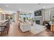 Open-concept living room with a fireplace, abundant natural light, hardwood floors and stylish contemporary furniture at 1016 Kinship Dr # 119, Lancaster, SC 29720