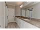 Bathroom with double sinks, granite countertops, and sliding barn door at 10209 New Town Rd, Marvin, NC 28173