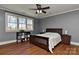 Bedroom featuring hardwood floors, a ceiling fan, and a window offering a scenic view at 10209 New Town Rd, Marvin, NC 28173