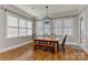 Dining room with a wooden table, windows with blinds and black modern chandelier at 10209 New Town Rd, Marvin, NC 28173