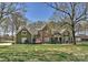 Expansive home with stone and wood exterior, professional landscaping, and a sprawling front lawn at 10209 New Town Rd, Marvin, NC 28173