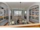 Grand foyer with high ceilings, wrought iron chandeliers, and arched entryways with bookshelves at 10209 New Town Rd, Marvin, NC 28173