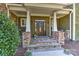Charming home exterior with stone accents, covered entryway, and detailed wood front door with glass panels at 10209 New Town Rd, Marvin, NC 28173