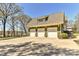 Detached three-car garage with a spacious driveway, providing ample parking and storage space at 10209 New Town Rd, Marvin, NC 28173