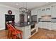 Open kitchen with white cabinets, granite countertops, kitchen island and stainless steel appliances at 10209 New Town Rd, Marvin, NC 28173
