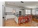 Bright, updated kitchen with stainless steel appliances, a center island with bar seating, and hardwood floors at 10209 New Town Rd, Marvin, NC 28173