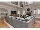 Bright living room with stone fireplace, large windows, hardwood floors, and cozy furniture arrangement at 10209 New Town Rd, Marvin, NC 28173