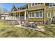Relax on the backyard patio with elegant seating and a stylish outdoor rug, complemented by the home's stone accents at 10209 New Town Rd, Marvin, NC 28173