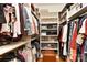 Walk-in closet with custom shelving units and an ottoman at 10209 New Town Rd, Marvin, NC 28173