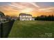 Expansive backyard with lush lawn, fenced perimeter, and outdoor patio area at 1022 Torrens Dr, Monroe, NC 28110