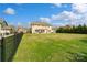 Expansive backyard with lush lawn, fenced perimeter, and outdoor patio area at 1022 Torrens Dr, Monroe, NC 28110