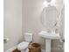 Bathroom featuring a pedestal sink, elongated toilet, and decorative lighting at 1022 Torrens Dr, Monroe, NC 28110