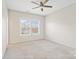 Cozy bedroom with carpet, ceiling fan, and a view from the bright window at 1022 Torrens Dr, Monroe, NC 28110