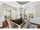 Elegant dining room with large windows, wainscoting, and an adjacent view of the home office at 1022 Torrens Dr, Monroe, NC 28110