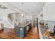 Bright kitchen features granite countertops, stainless steel appliances, kitchen island with seating, and hardwood flooring at 1022 Torrens Dr, Monroe, NC 28110
