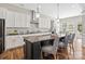 Bright kitchen features granite countertops, stainless steel appliances, kitchen island with seating and decorative lighting at 1022 Torrens Dr, Monroe, NC 28110