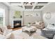 Cozy living room features a fireplace, coffered ceilings, hardwood floors and lots of natural light at 1022 Torrens Dr, Monroe, NC 28110
