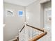 Upstairs landing with wood and white banister at 1022 Torrens Dr, Monroe, NC 28110