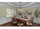 Elegant dining room featuring a decorative chandelier, stylish furnishings, and large windows for natural light at 10415 Waxhaw Manor Dr, Waxhaw, NC 28173