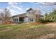 Large backyard with screened in porch, brick patio, and manicured landscaping at 1061 Verbena Ct, Tega Cay, SC 29708