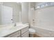 All-white bathroom with tile flooring, toilet, vanity, and soaking tub at 1061 Verbena Ct, Tega Cay, SC 29708