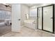 Bright bathroom with a glass door shower and soaking tub with tile flooring at 1061 Verbena Ct, Tega Cay, SC 29708