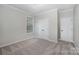 Neutral bedroom featuring carpet, crown molding, bright window, and closet doors at 1061 Verbena Ct, Tega Cay, SC 29708