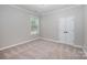 Neutral bedroom featuring carpet, crown molding, and a bright window at 1061 Verbena Ct, Tega Cay, SC 29708