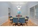 Elegant dining room with hardwood floors, wainscoting, and a chandelier, perfect for hosting dinner parties at 1061 Verbena Ct, Tega Cay, SC 29708