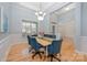 Elegant dining room with hardwood floors, wainscoting, and a chandelier, perfect for hosting dinner parties at 1061 Verbena Ct, Tega Cay, SC 29708
