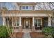 Inviting front porch featuring stone columns and seating area, perfect for relaxing and enjoying the outdoors at 1061 Verbena Ct, Tega Cay, SC 29708
