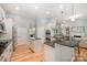 Spacious kitchen with a center island, black countertops, stainless appliances, and hardwood floors at 1061 Verbena Ct, Tega Cay, SC 29708
