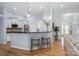 Modern kitchen with stylish stools, sleek countertops, stainless steel appliances, and open floor plan at 1061 Verbena Ct, Tega Cay, SC 29708