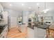 Spacious kitchen with a center island, black countertops, stainless appliances, and hardwood floors at 1061 Verbena Ct, Tega Cay, SC 29708