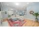 Bright living room with hardwood floors, a large comfortable sectional couch, and an colorful area rug at 1061 Verbena Ct, Tega Cay, SC 29708