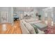 Open floor plan showcases a cozy living room with a large sectional, with a view of the adjacent dining and kitchen areas at 1061 Verbena Ct, Tega Cay, SC 29708