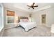 Inviting main bedroom featuring tray ceiling, large windows, natural light, and plush carpeting at 1061 Verbena Ct, Tega Cay, SC 29708