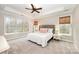 Inviting main bedroom featuring tray ceiling, large windows, natural light, and plush carpeting at 1061 Verbena Ct, Tega Cay, SC 29708