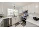 White kitchen features stainless steel appliances and checkered flooring at 1081 Evergreen Cir, Rock Hill, SC 29732