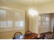 Bright dining room featuring plantation shutters and a classic chandelier above a wood table at 109 Oakland Ave, Chester, SC 29706