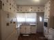 Classic kitchen with white cabinets, stainless steel appliances, and abundant natural light at 109 Oakland Ave, Chester, SC 29706