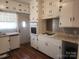 Bright kitchen featuring white cabinets, built in oven and hardwood style floors at 109 Oakland Ave, Chester, SC 29706