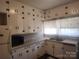 Traditional kitchen featuring white cabinets, light countertops, and stainless steel appliances at 109 Oakland Ave, Chester, SC 29706