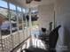 Screened porch with a glass table, four chairs and views of the yard and neighborhood at 109 Oakland Ave, Chester, SC 29706