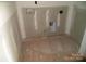 Unfinished laundry room awaiting appliances, showcasing raw concrete floor and wall utilities ready for setup at 128 Peppervine Ln, Statesville, NC 28625