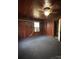 Bedroom with wood paneled walls features a ceiling fan and window with an AC unit at 1335 Kings Cir, Shelby, NC 28150