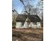 Exterior view of a house surrounded by trees and brush in need of major repair at 1335 Kings Cir, Shelby, NC 28150