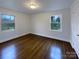 Neat bedroom with hardwood floors and bright windows providing ample natural light at 1429 Alexander Rd, Rock Hill, SC 29732