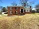 Charming brick home with black shutters, a well-maintained yard, and a stone walkway at 1429 Alexander Rd, Rock Hill, SC 29732