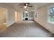 Spacious living room featuring neutral carpet, bright windows, and custom built-in shelving at 1429 Alexander Rd, Rock Hill, SC 29732
